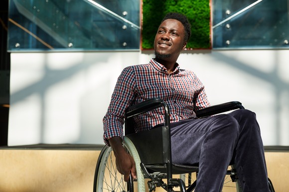 Person smiling in a wheelchair.