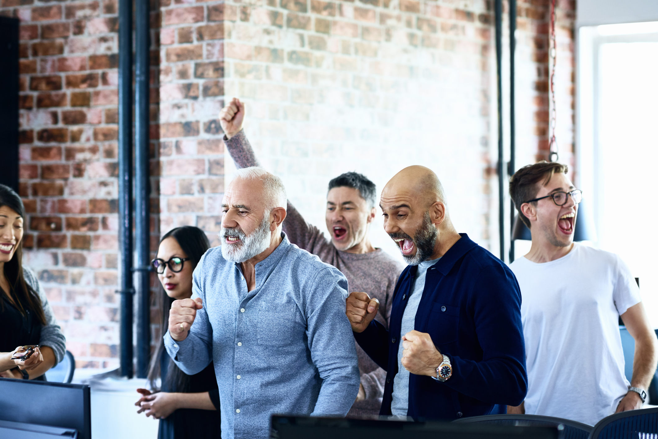 People in an office cheering.