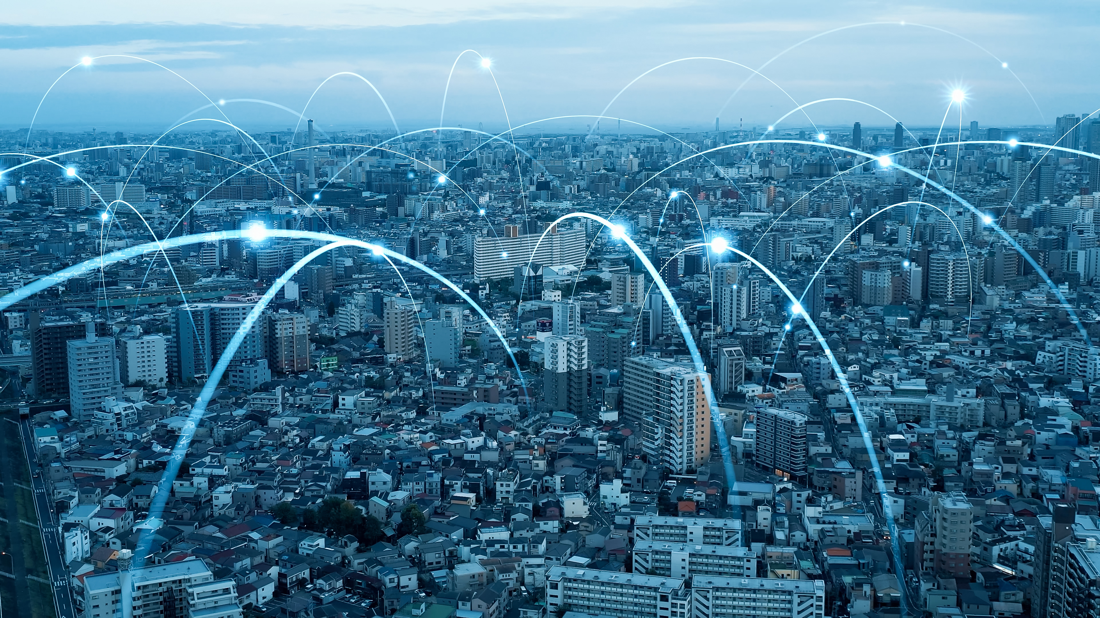 An aerial view of a "smart city" with connecting lines around it.