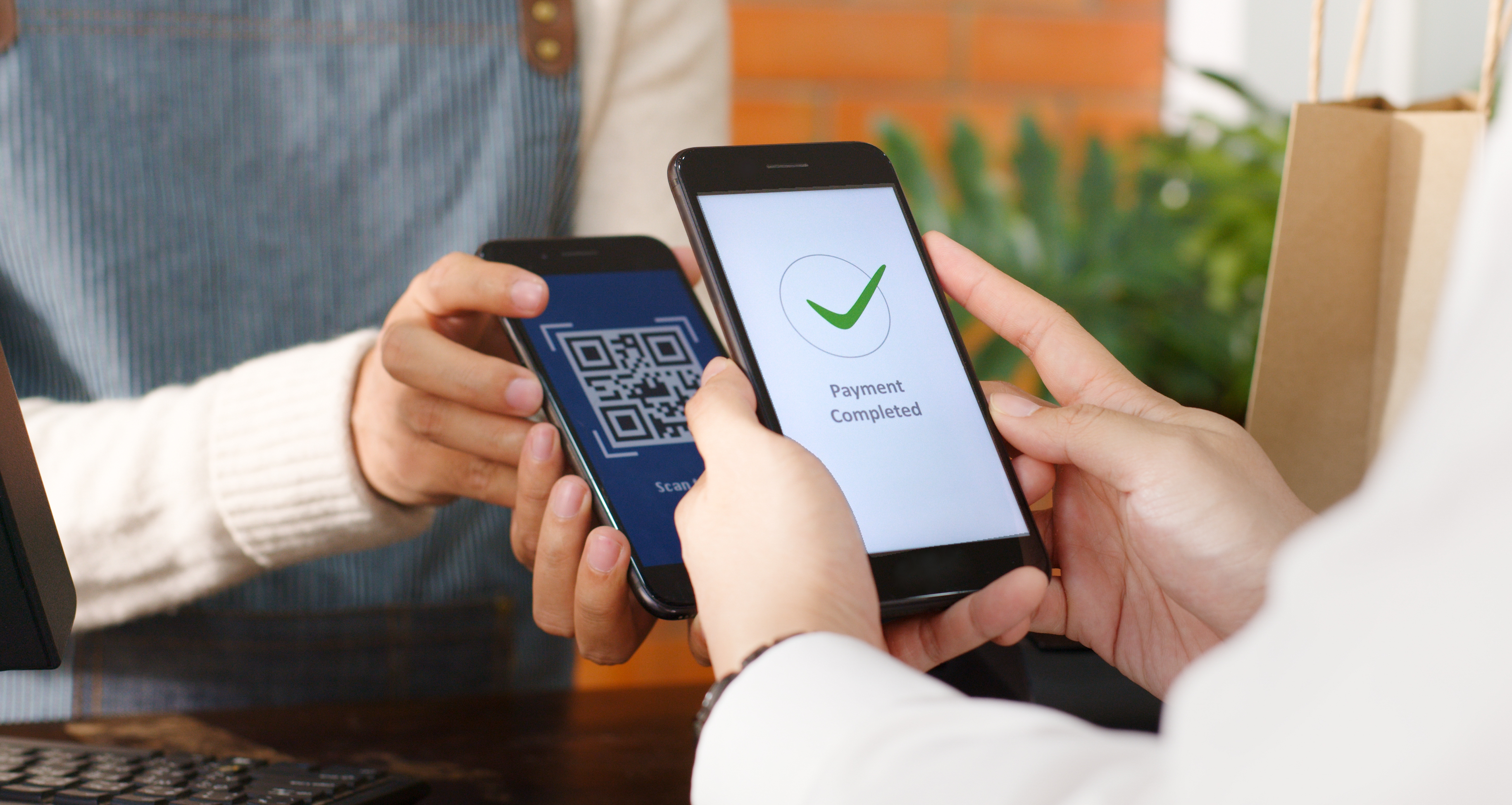 People using smart phones for contactless payments.