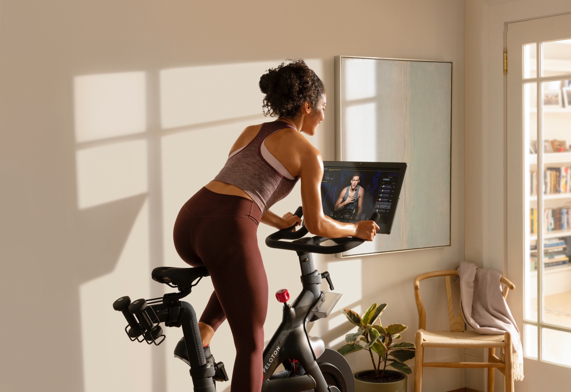 Woman riding a connected exercise bike.