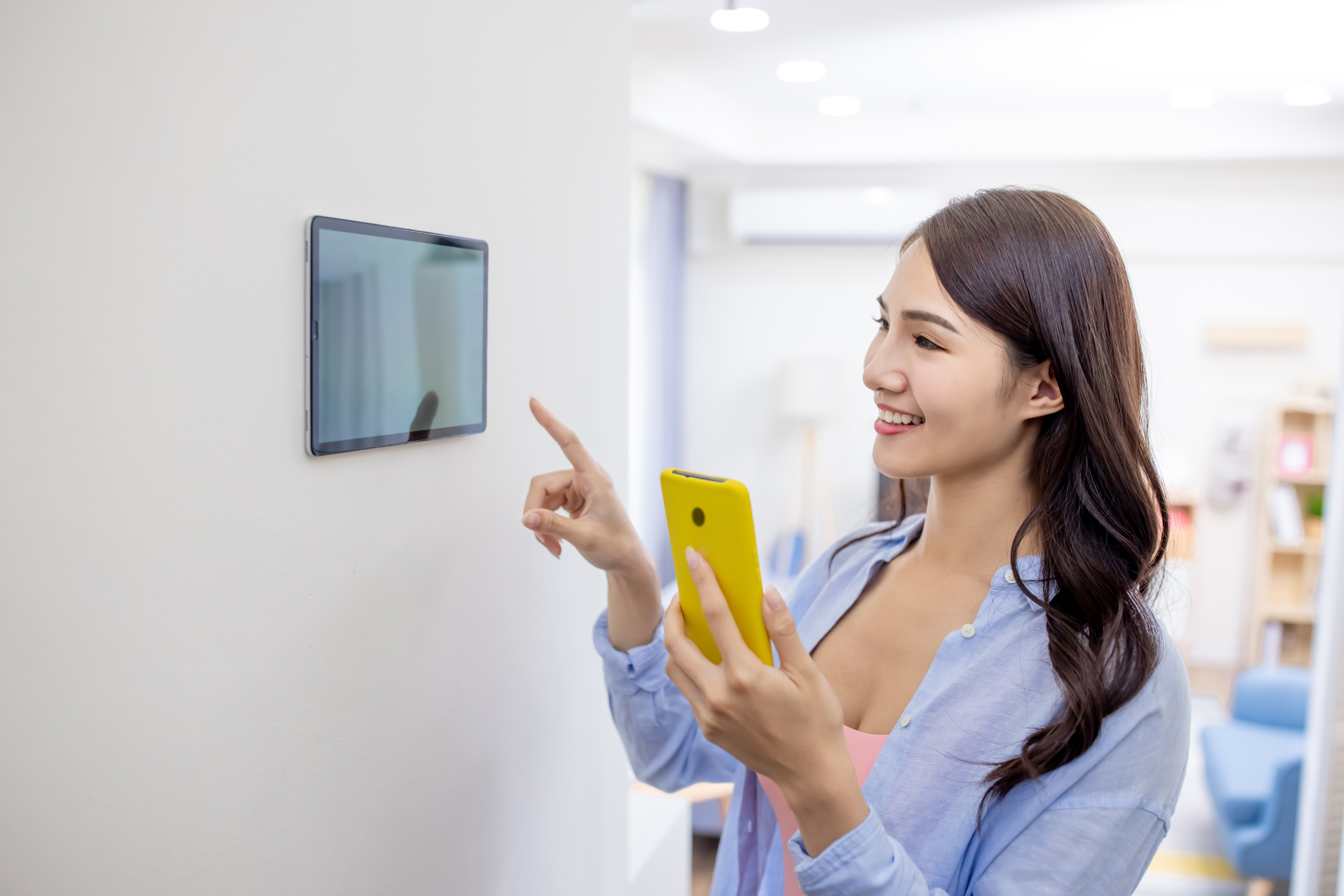 Person controls home features through smart phone and tablet.