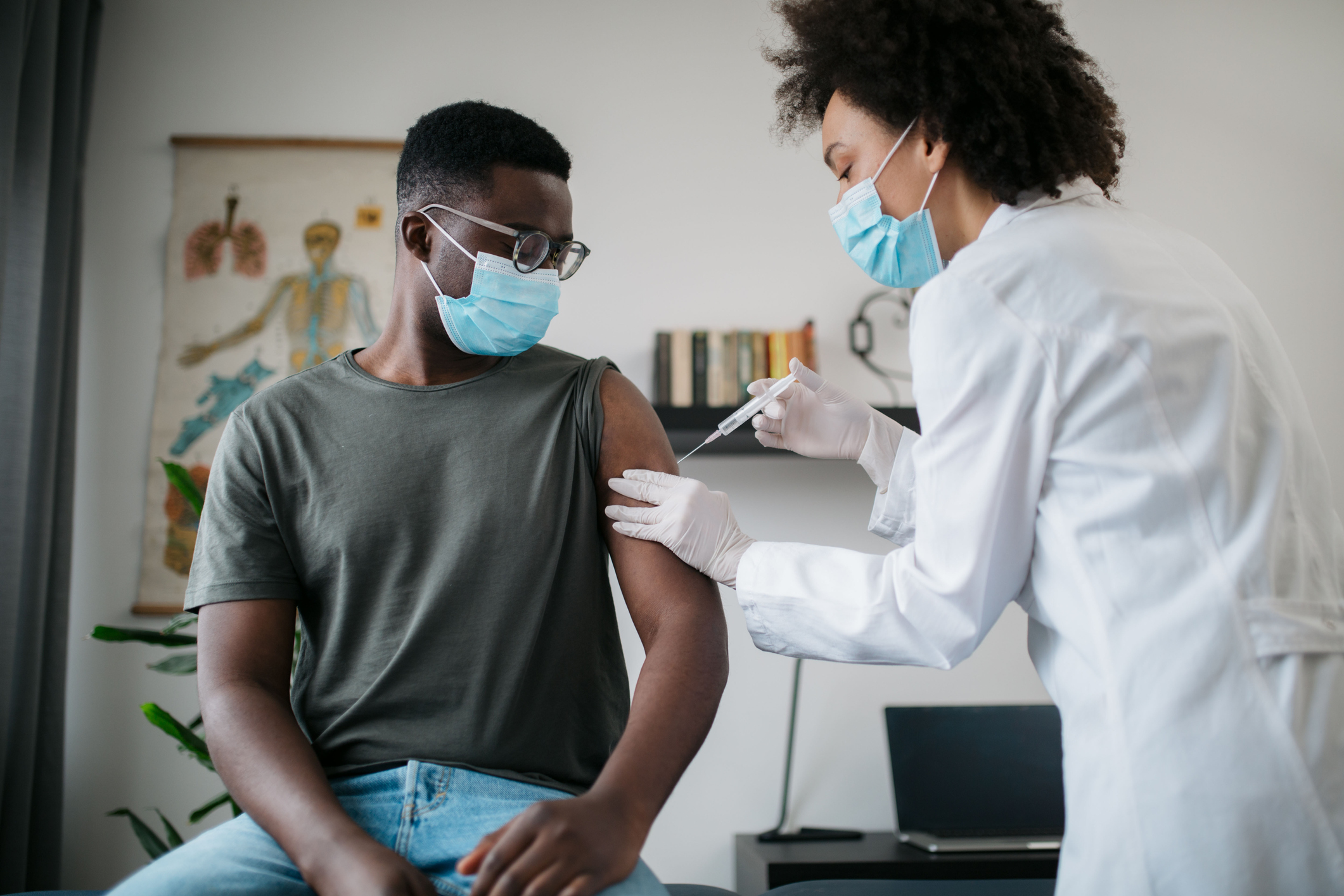 Vaccine - doctor giving a shot to a young man