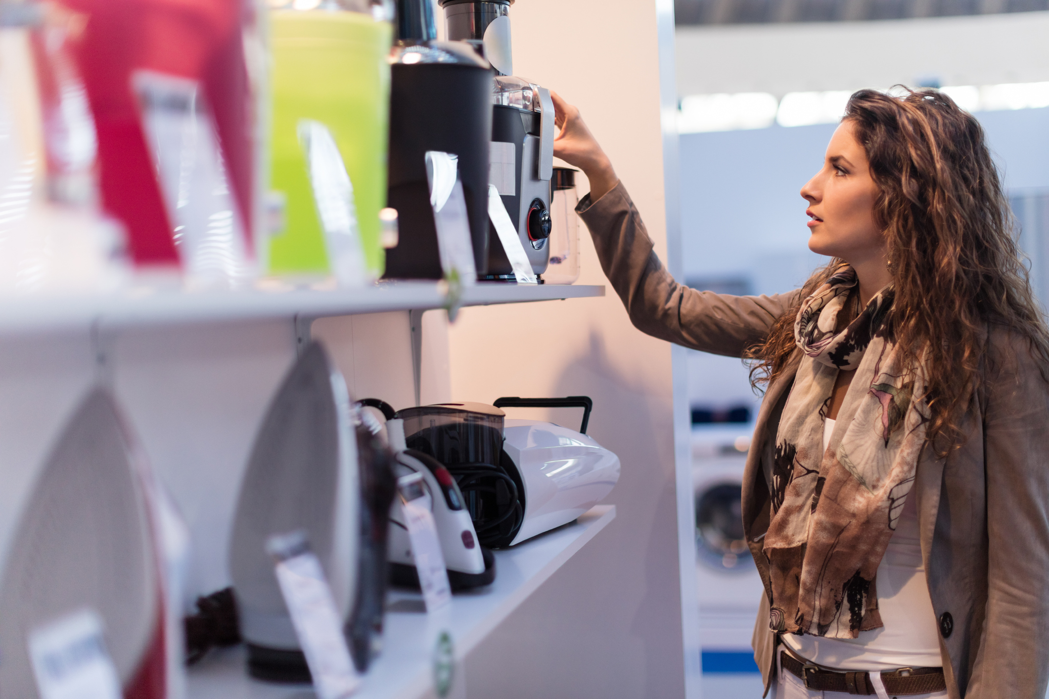 A young person shopping for small appliances.