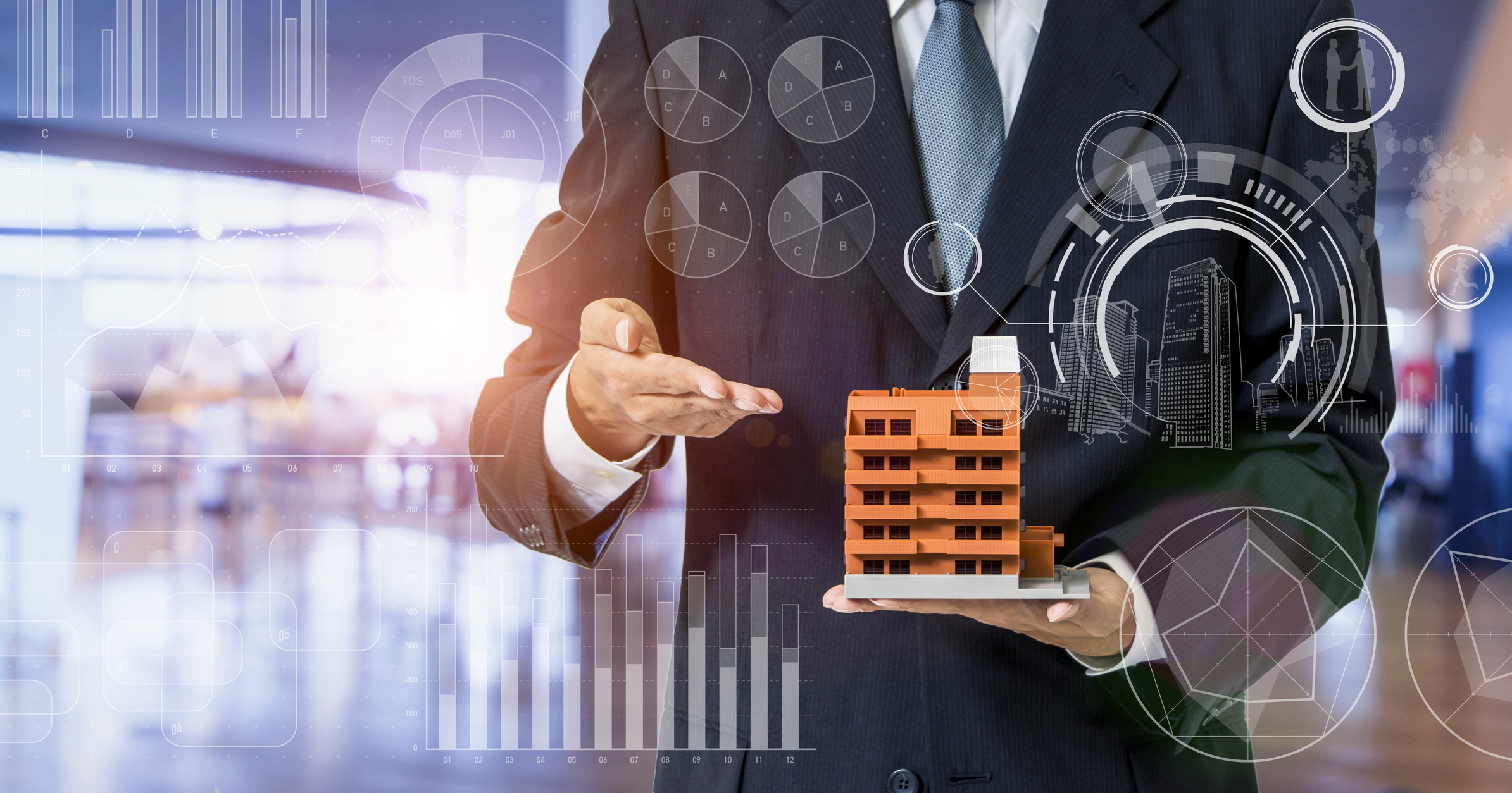 A person holding a building in their hand.