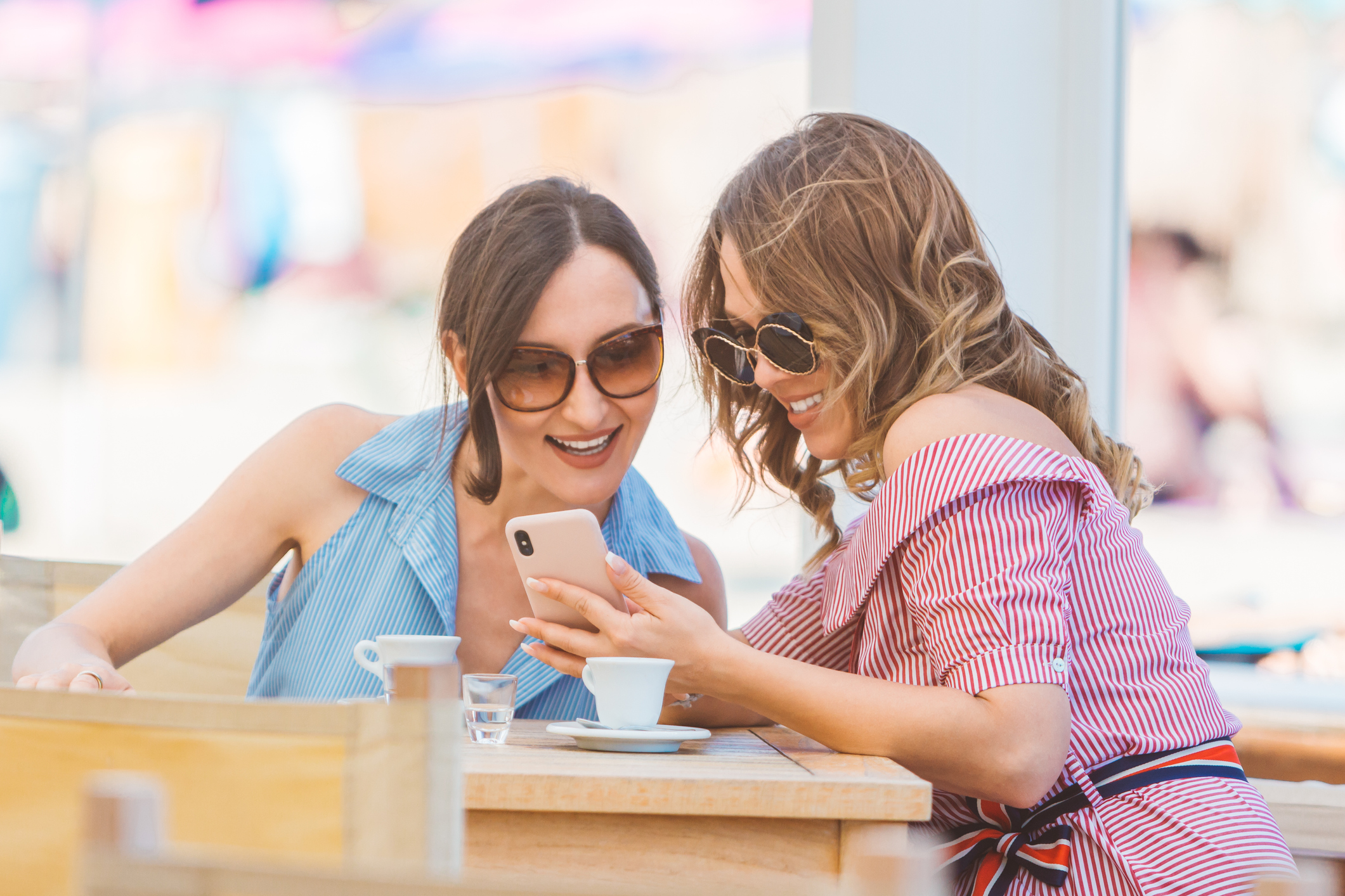 Two people looking at a phone.