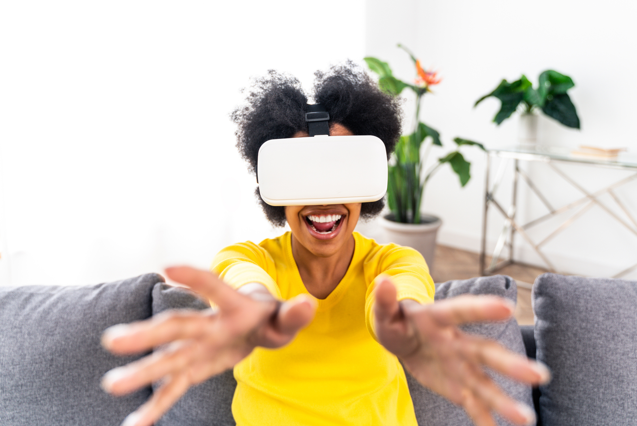 A person wearing a virtual reality headset who's reaching out with their hands.