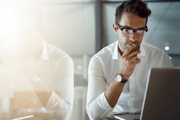 A business person looking at a computer.