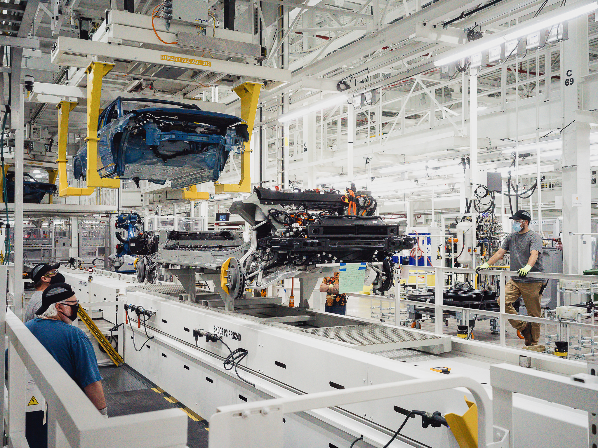 R1T being placed on its frame in assembly line.