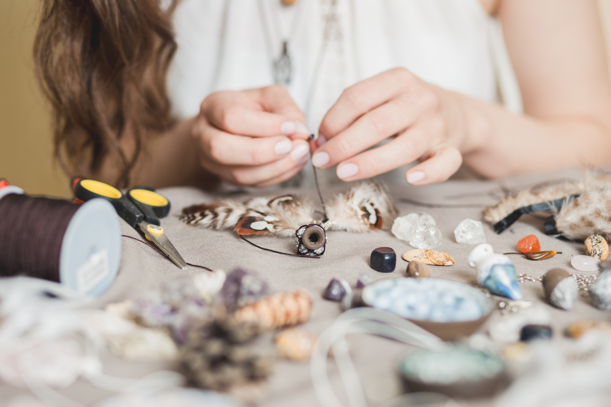 Person crafting with shells.