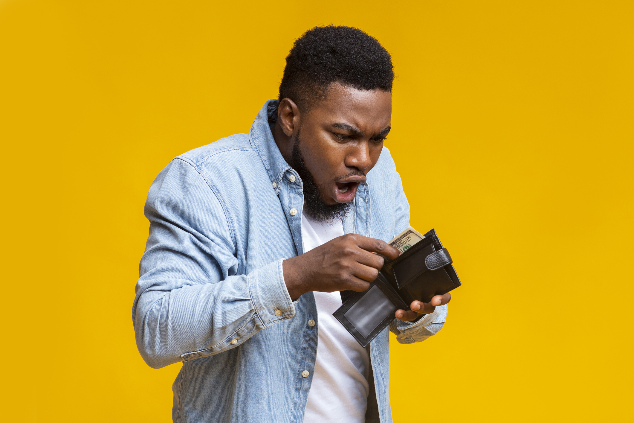 Person pulling cash out of a wallet.
