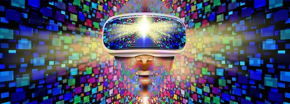 Person wearing virtual reality goggles with a colorful background.