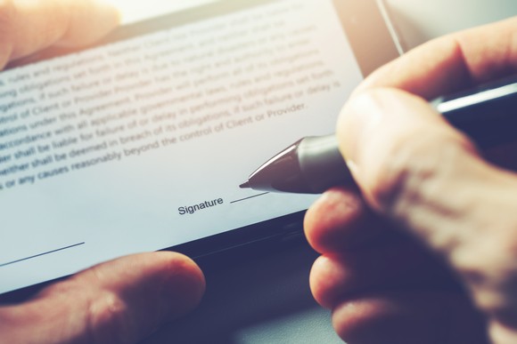 Hand signing a document digitally.