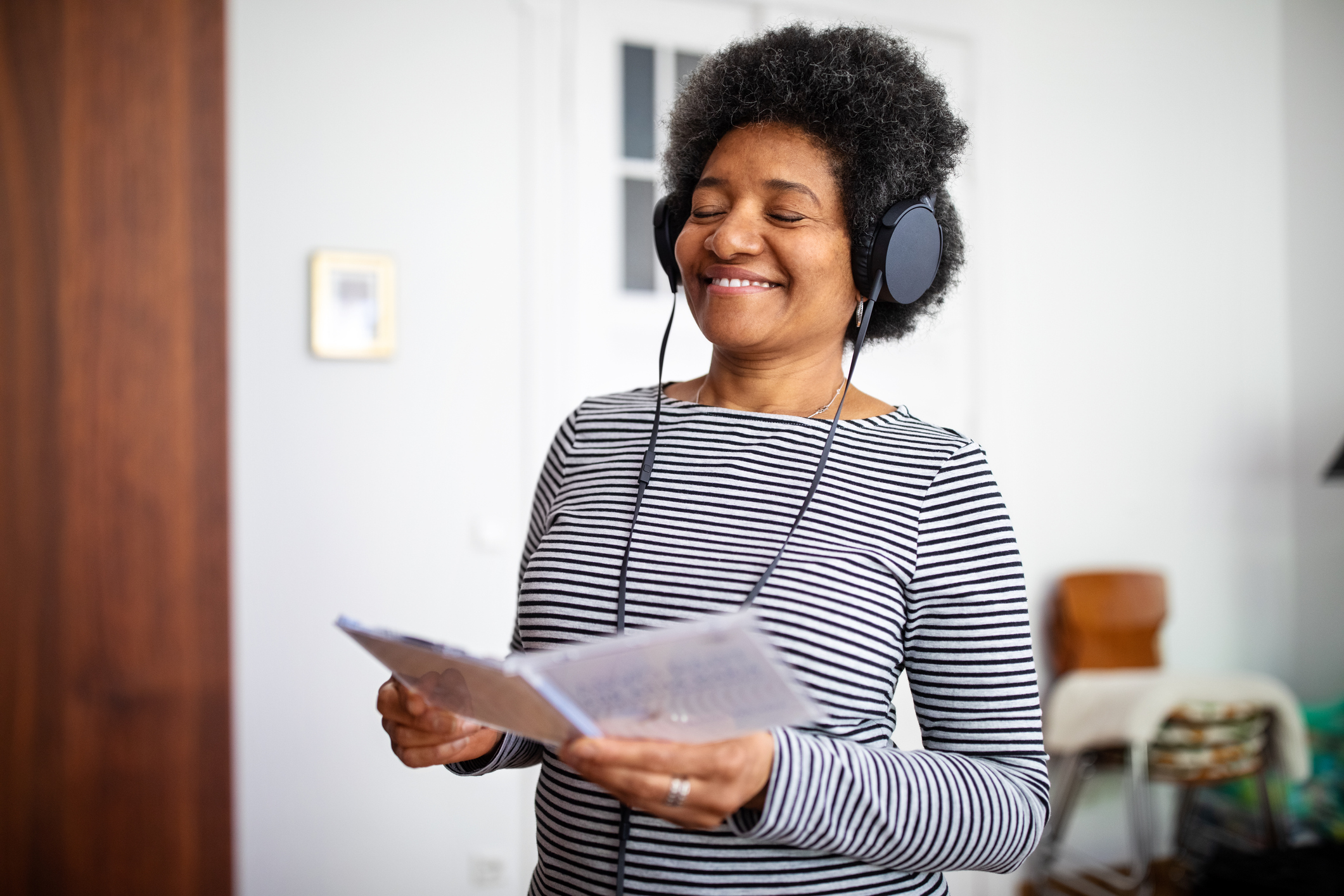 A person listening to headphones with their eyes closed.
