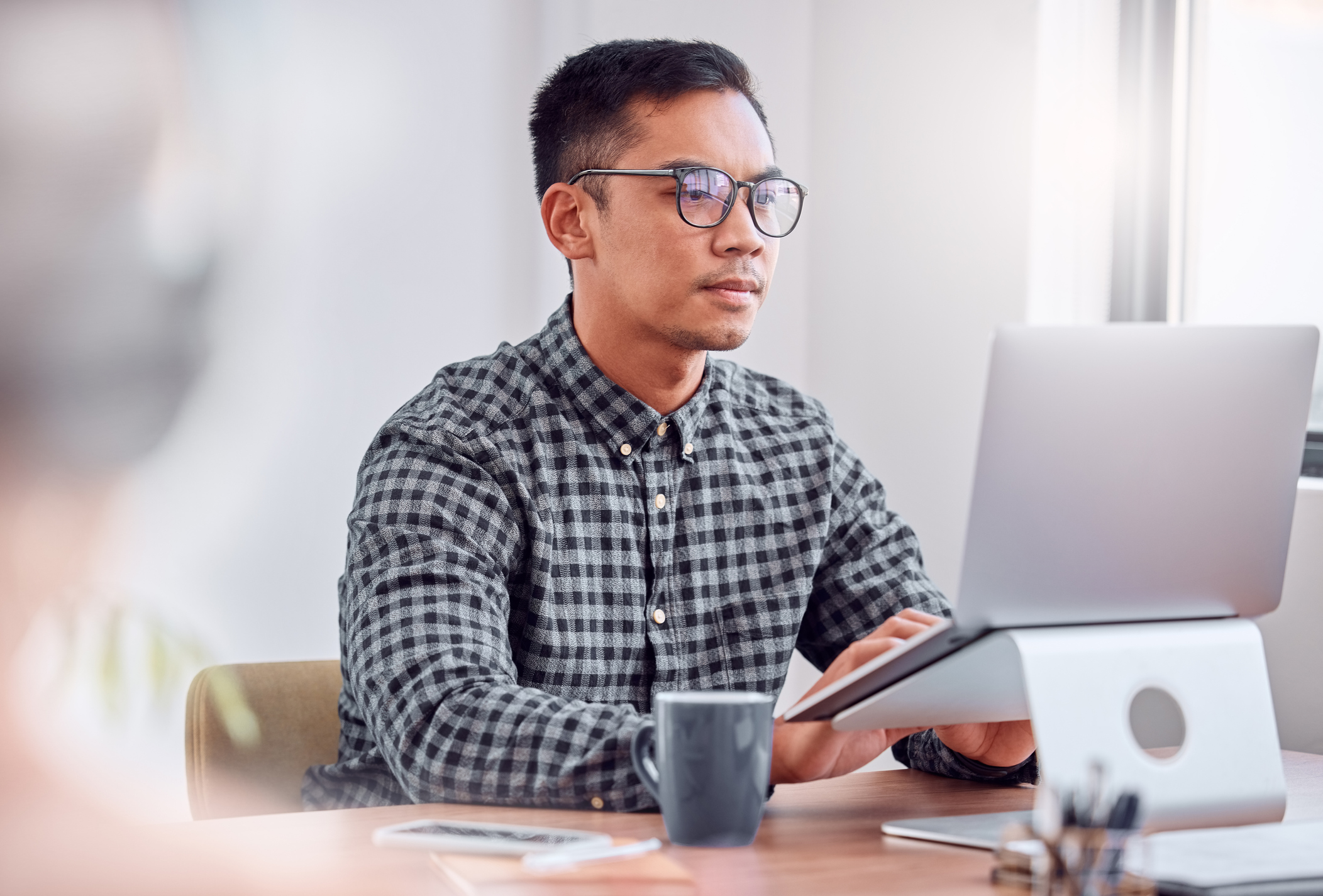 A person staring at a laptop screen.