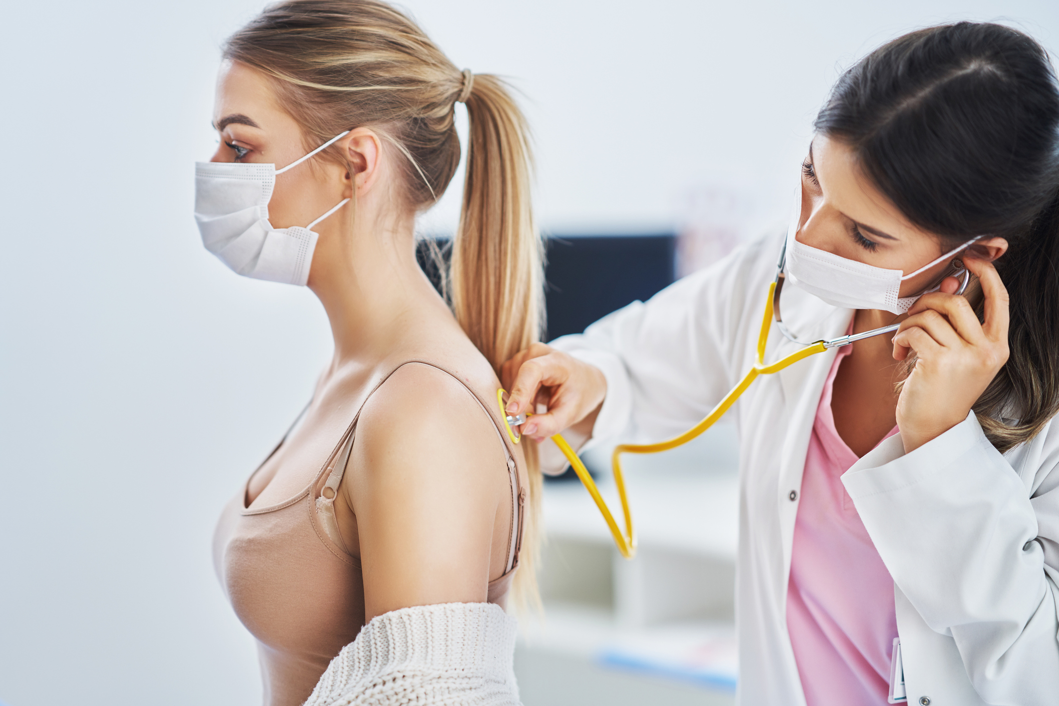 A doctor examines a patient with a stethoscope.