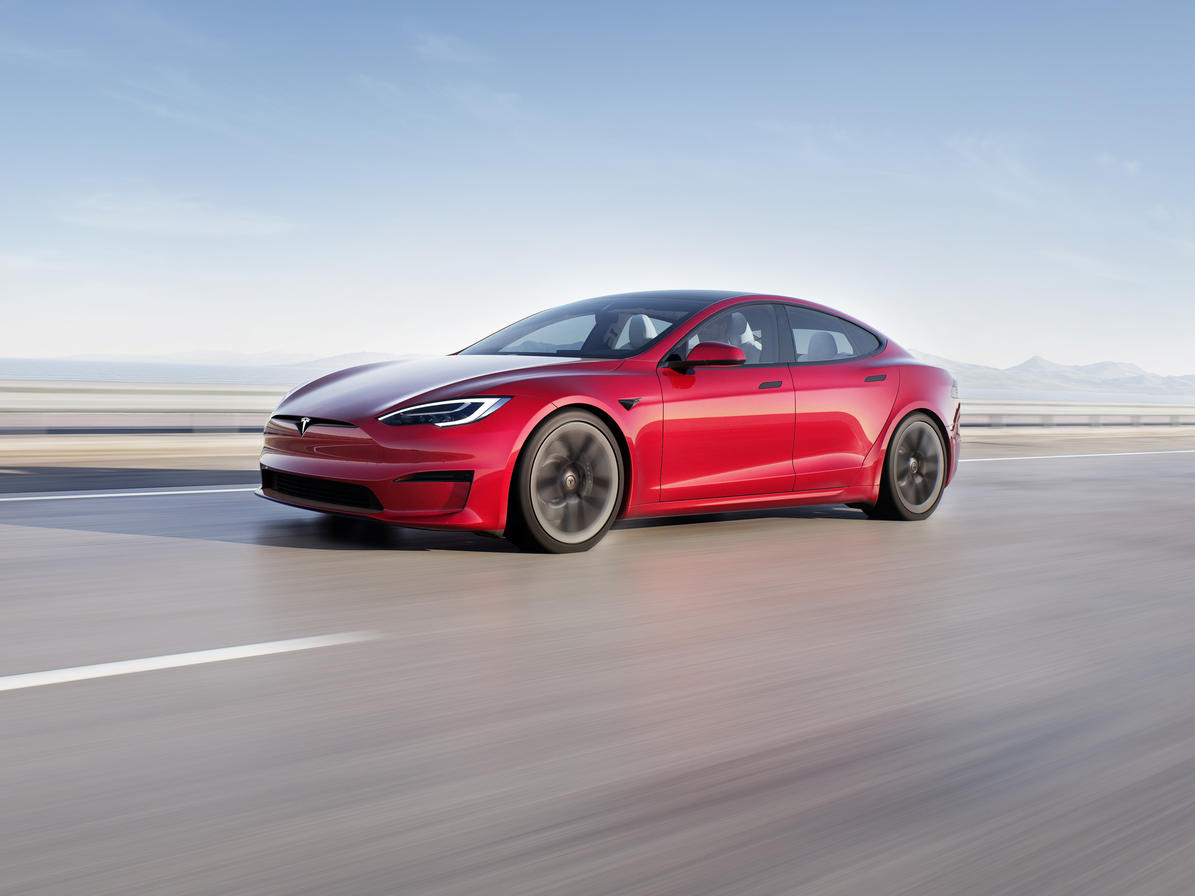 Tesla Model S in motion on a road.