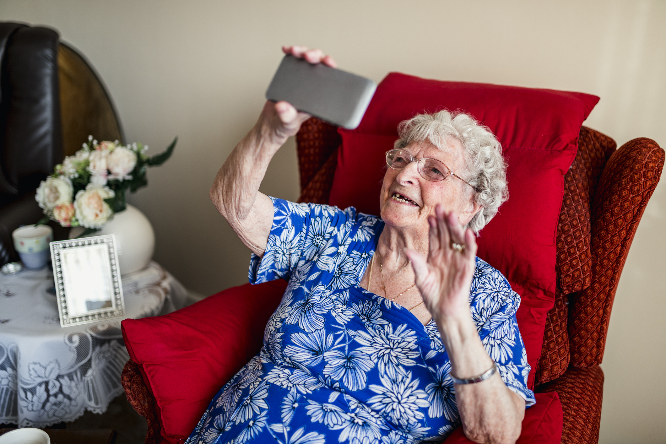 Holding up their cellphone in a nursing home