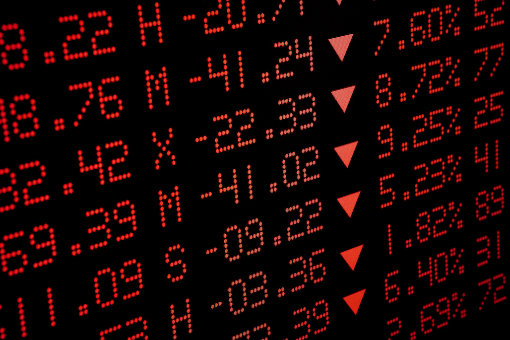 An electronic display board shows stock prices falling.