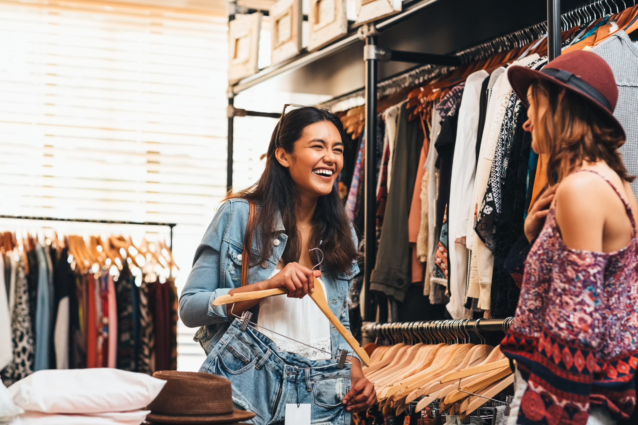 Two friends go shopping for clothes.