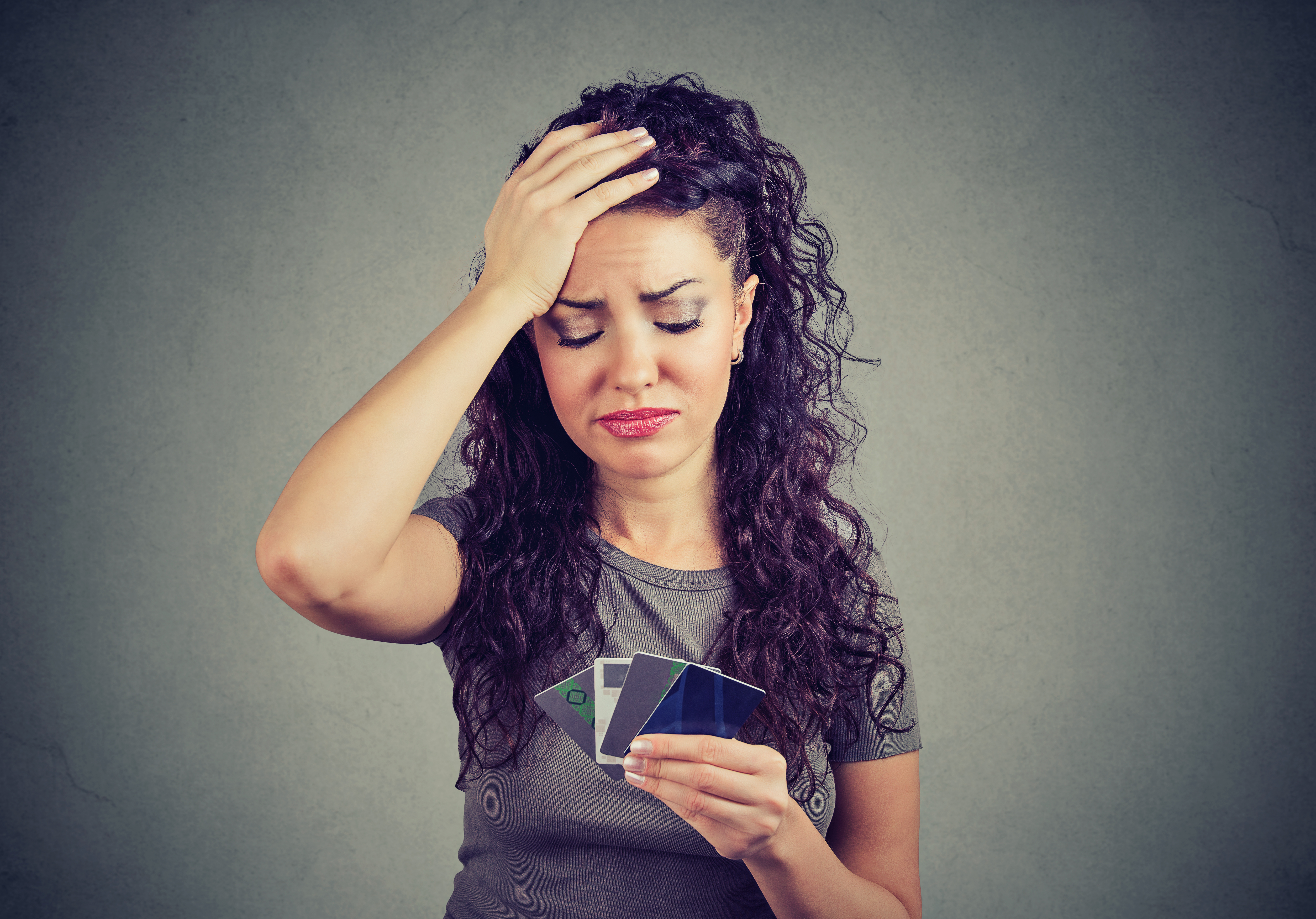 Person looking at credit cards concerned.