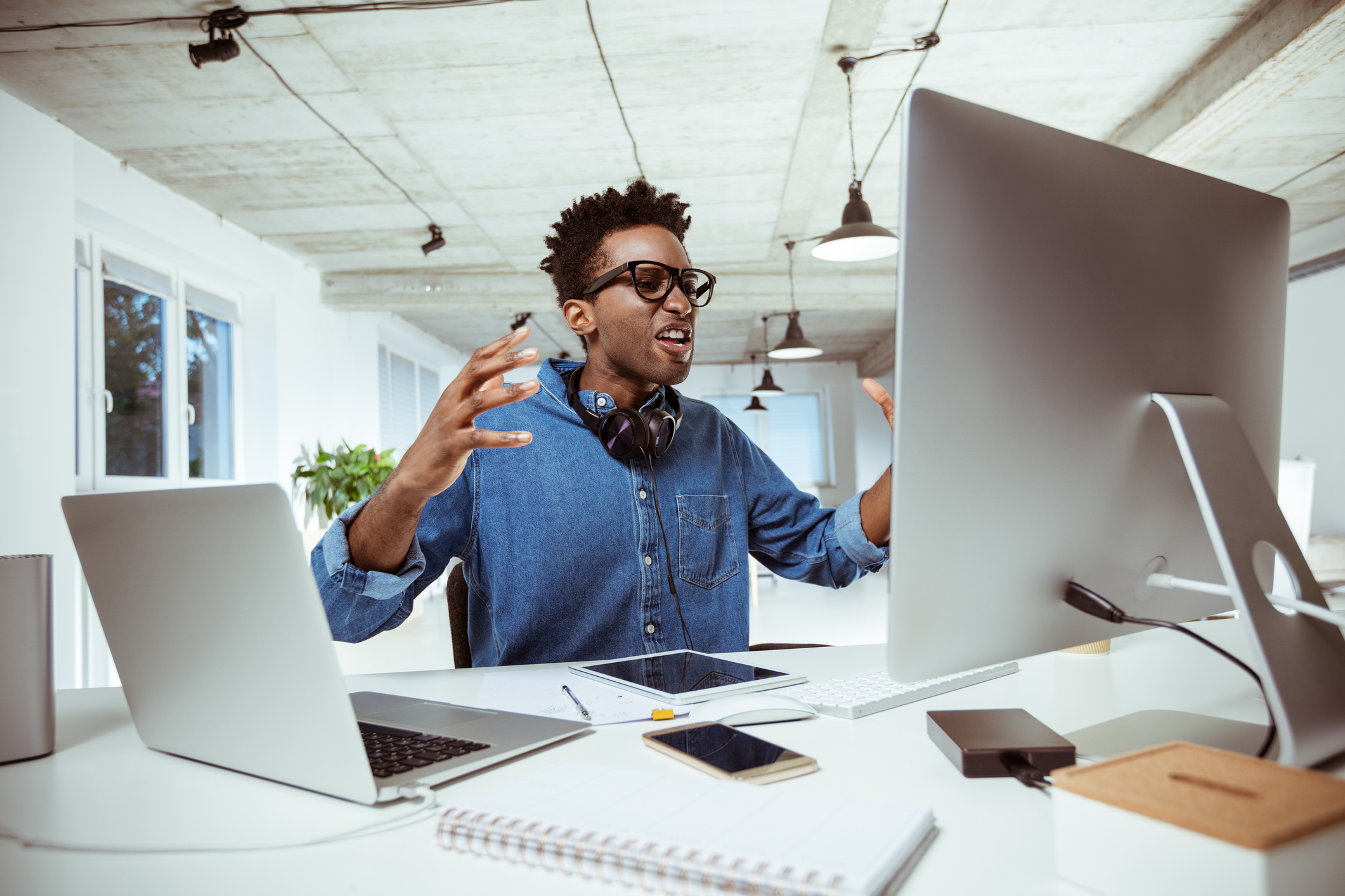 Irate person looking at a PC monitor.