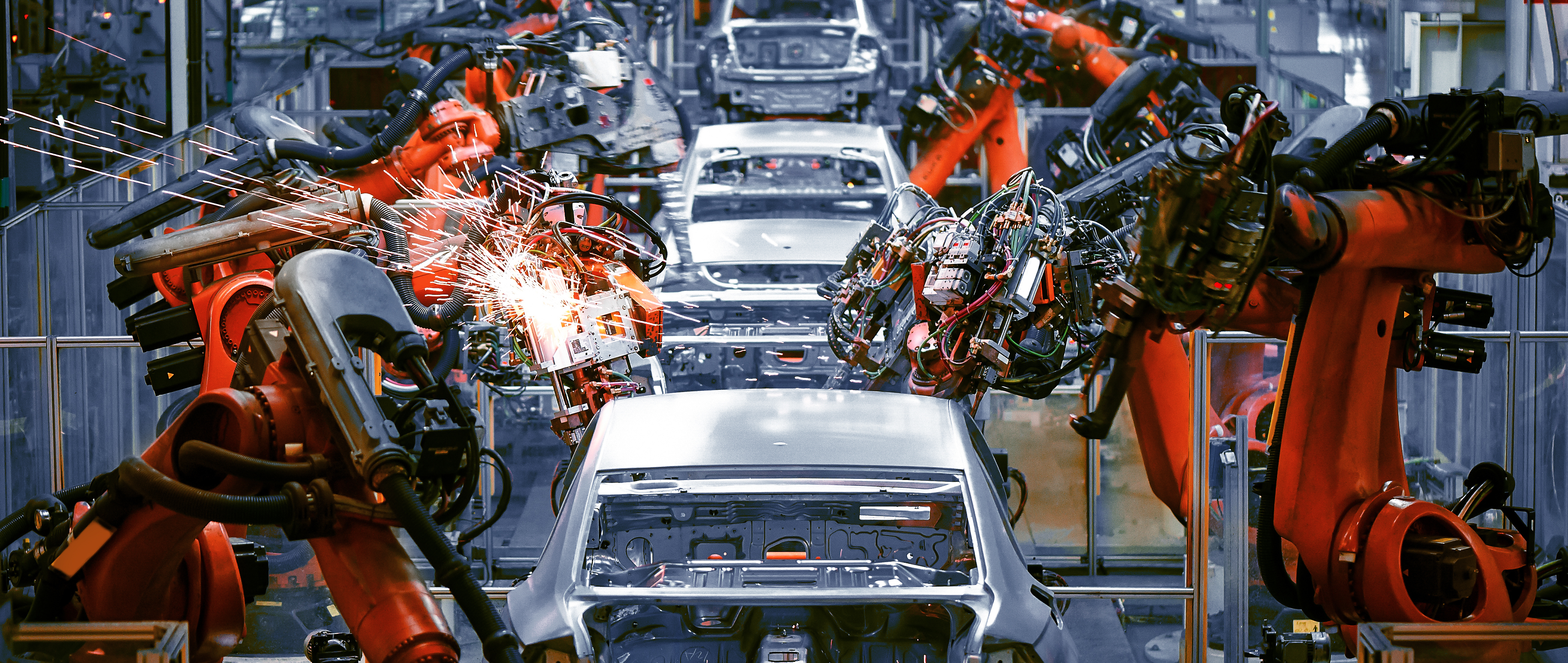 Cars on an assembly line.