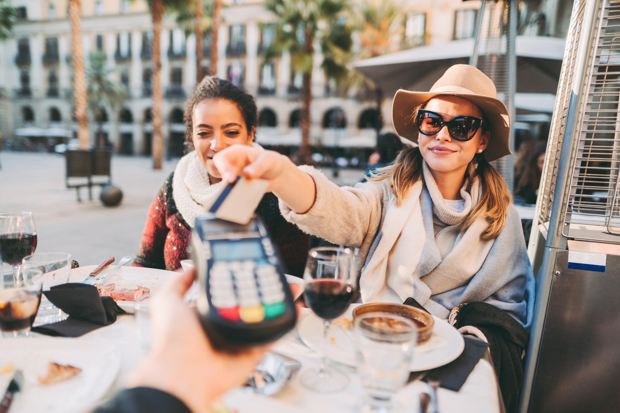 A person uses a credit card to pay at a restaurant.