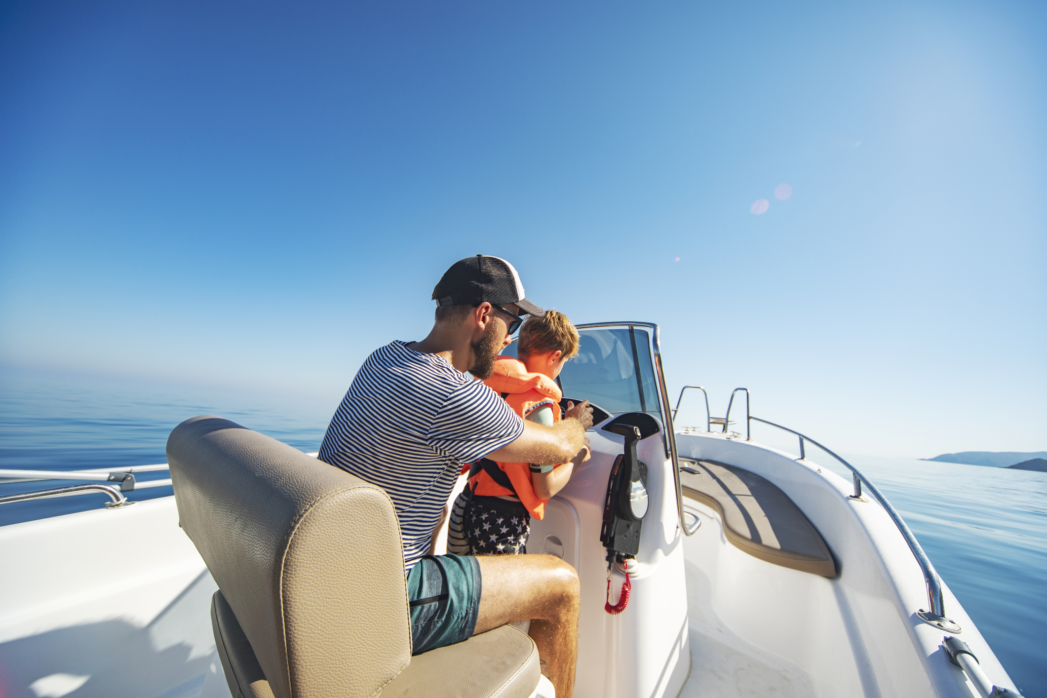 person with child driving boat