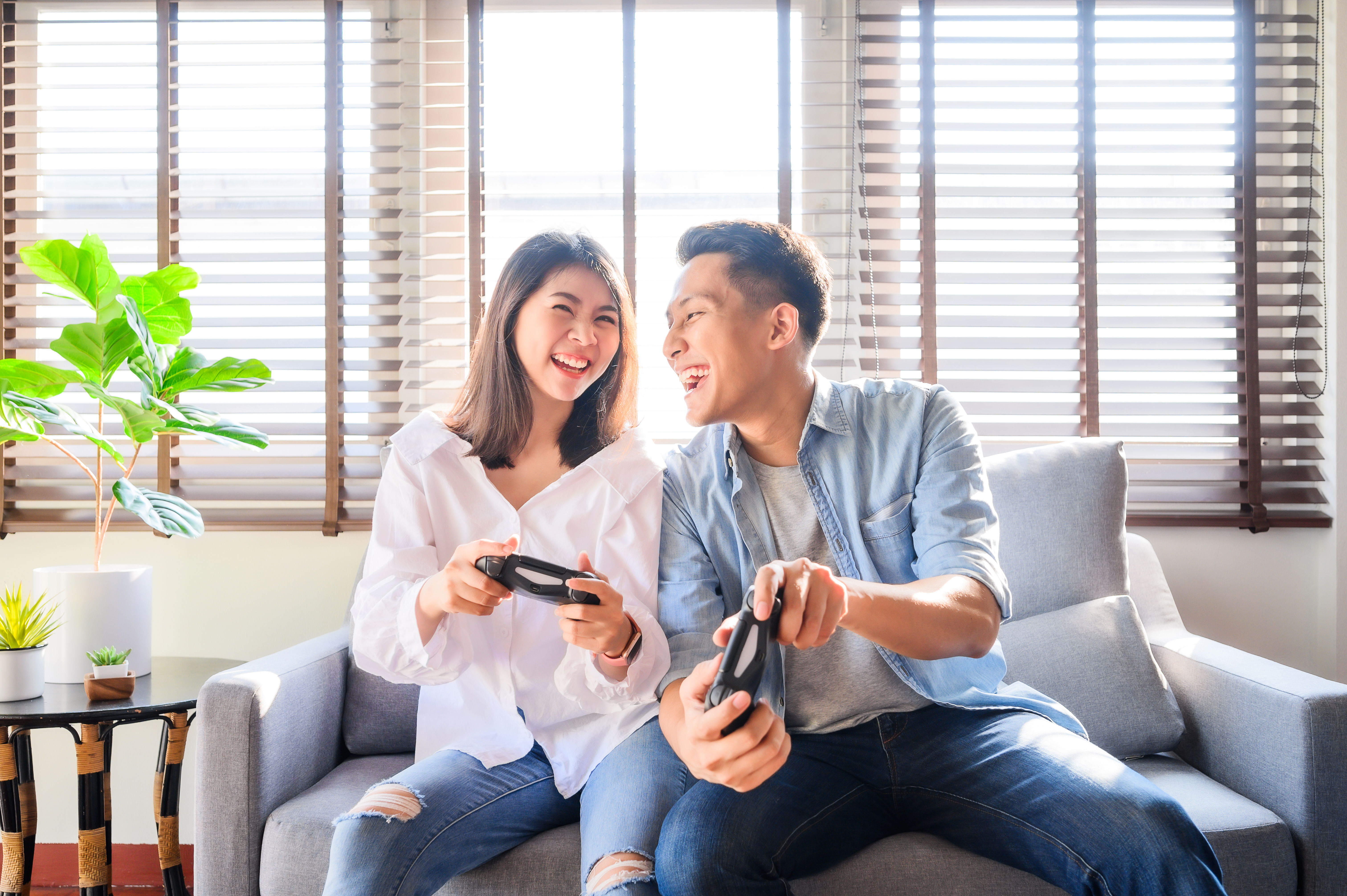 Happy people playing video games at home.