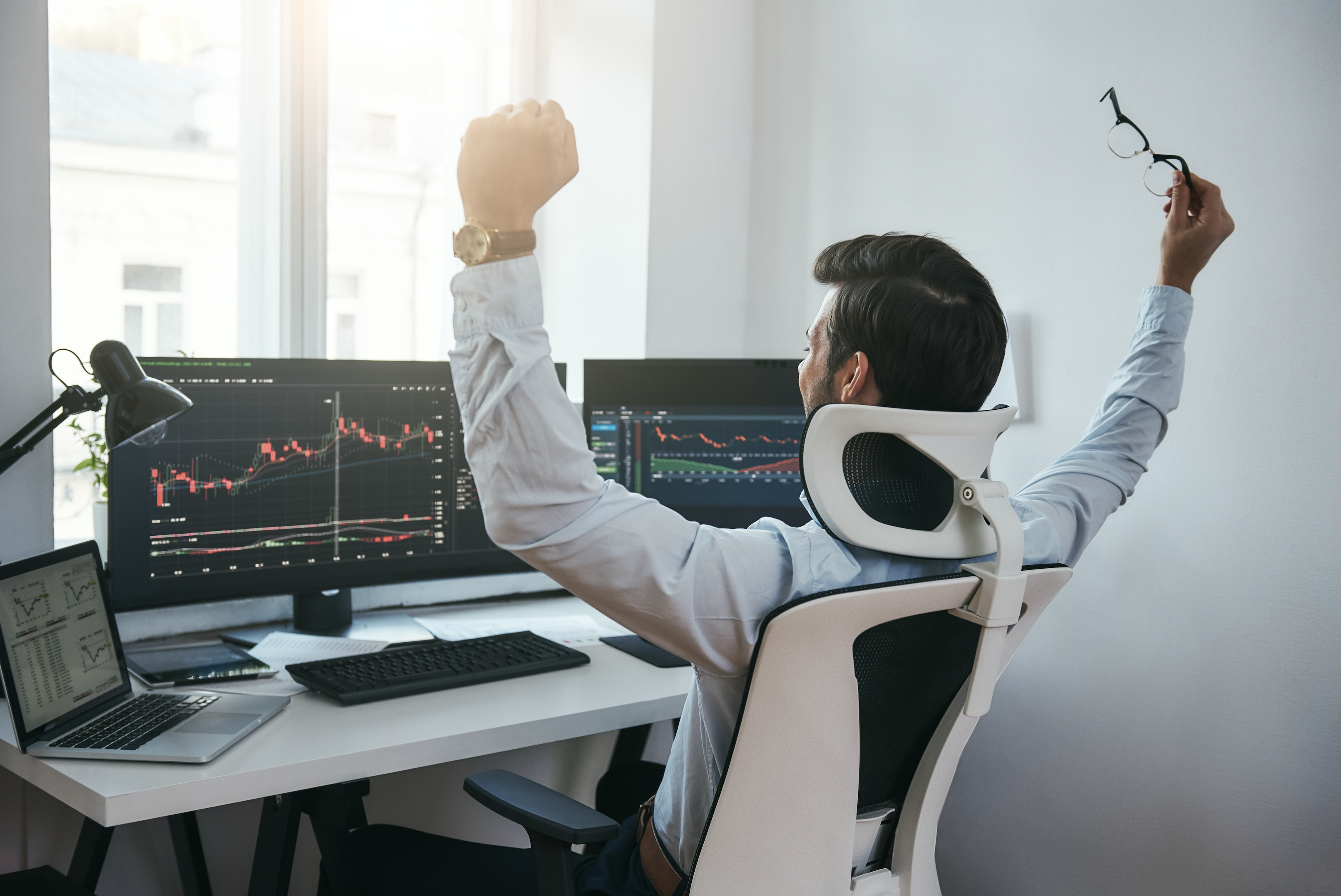happy trader watching stock charts