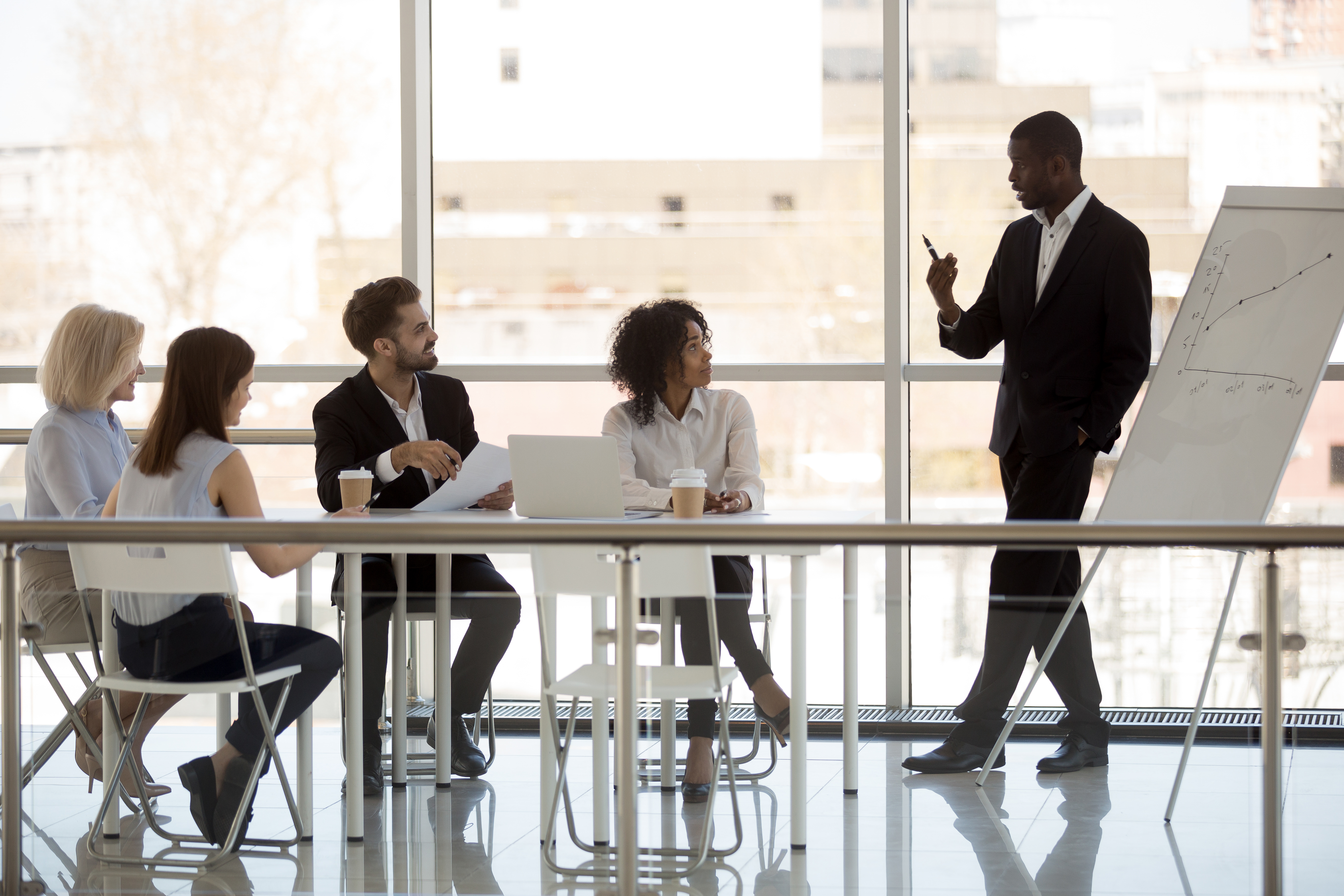 A consultant presenting in an office meeting.