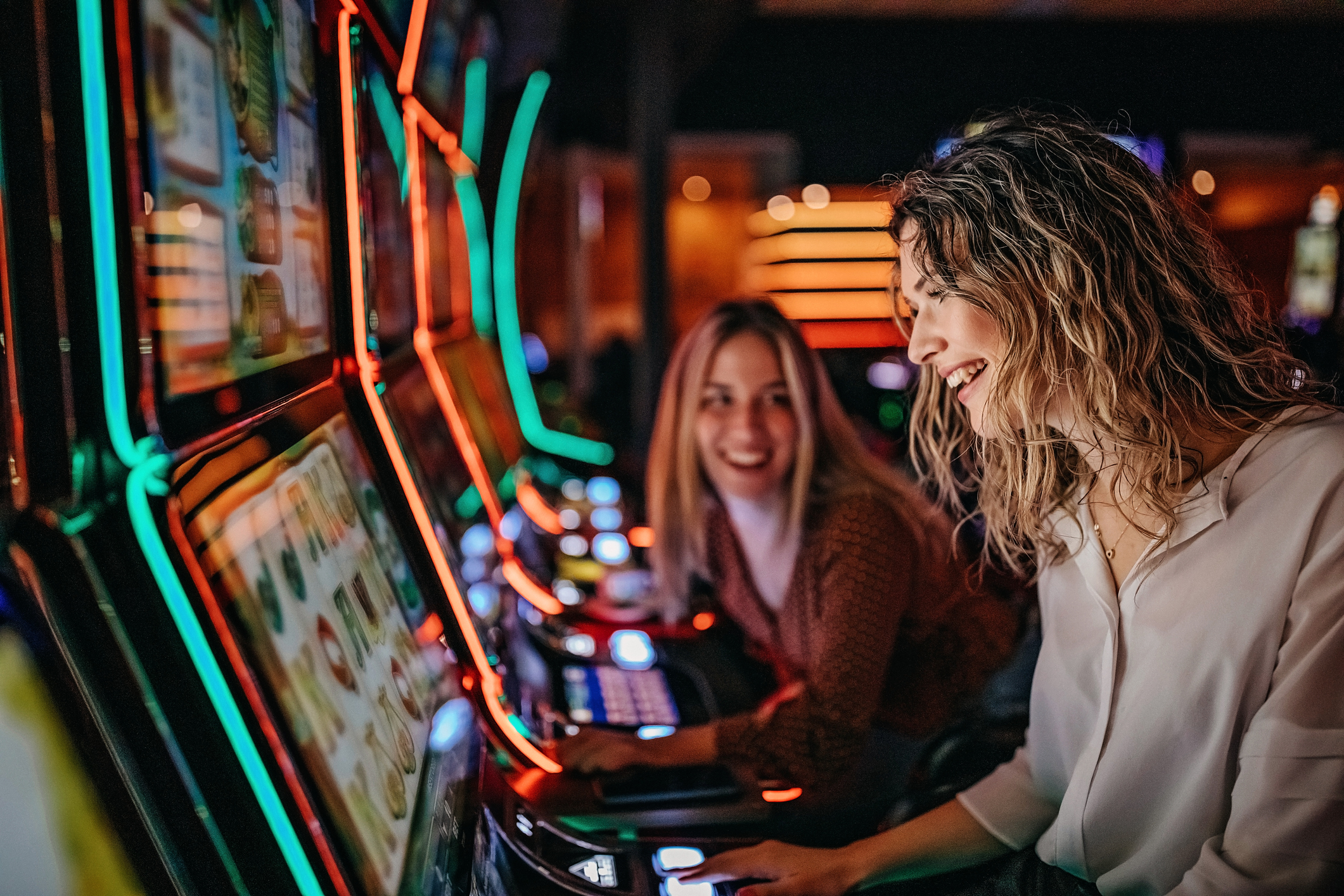 People playing slot machines at a casino