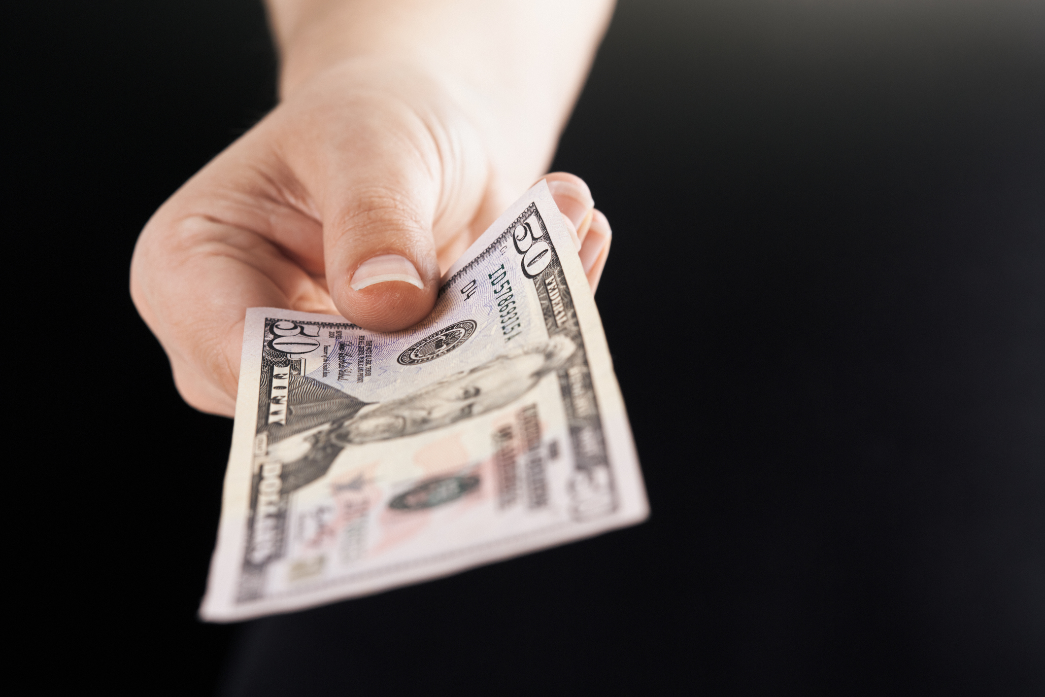 Person paying fifty-dollar bill.