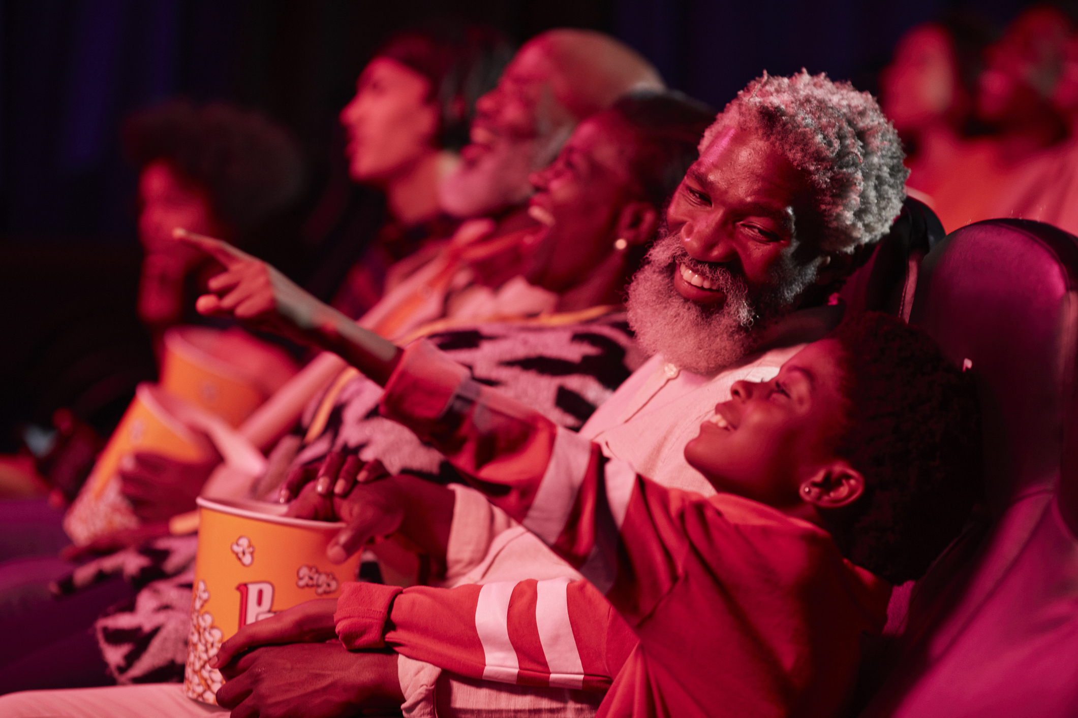 Smiling family in theater.