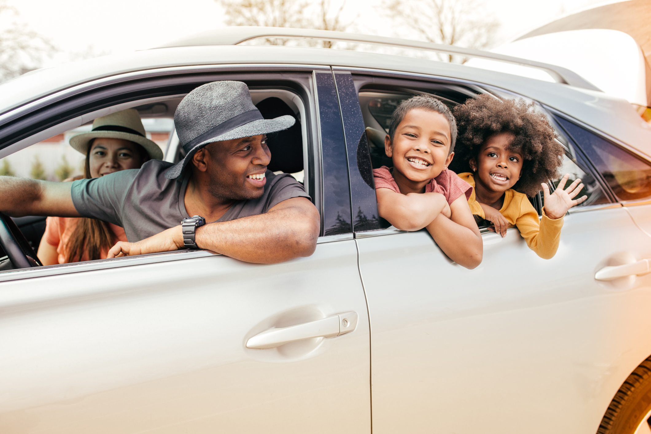 Smiling people are in a car together.