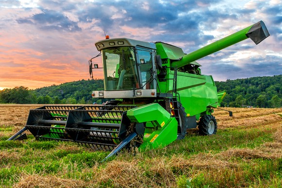 Green combine in a field.