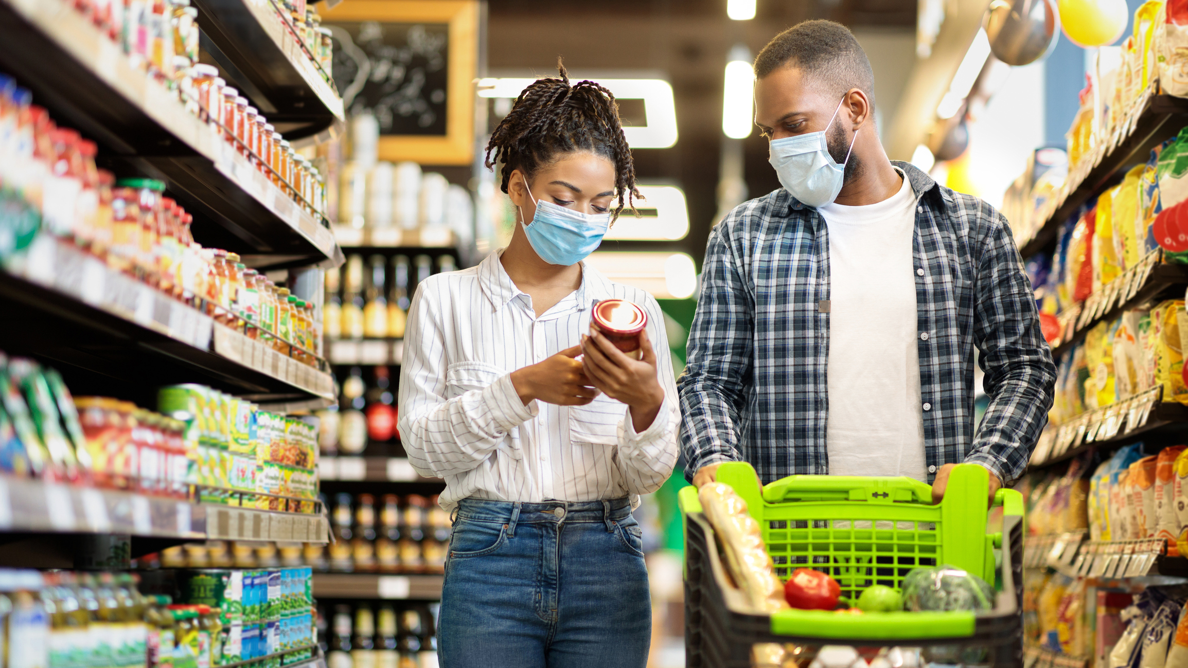 Two people shop at a grocery store