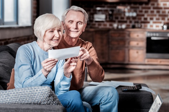 Two people looking at check in living room. 