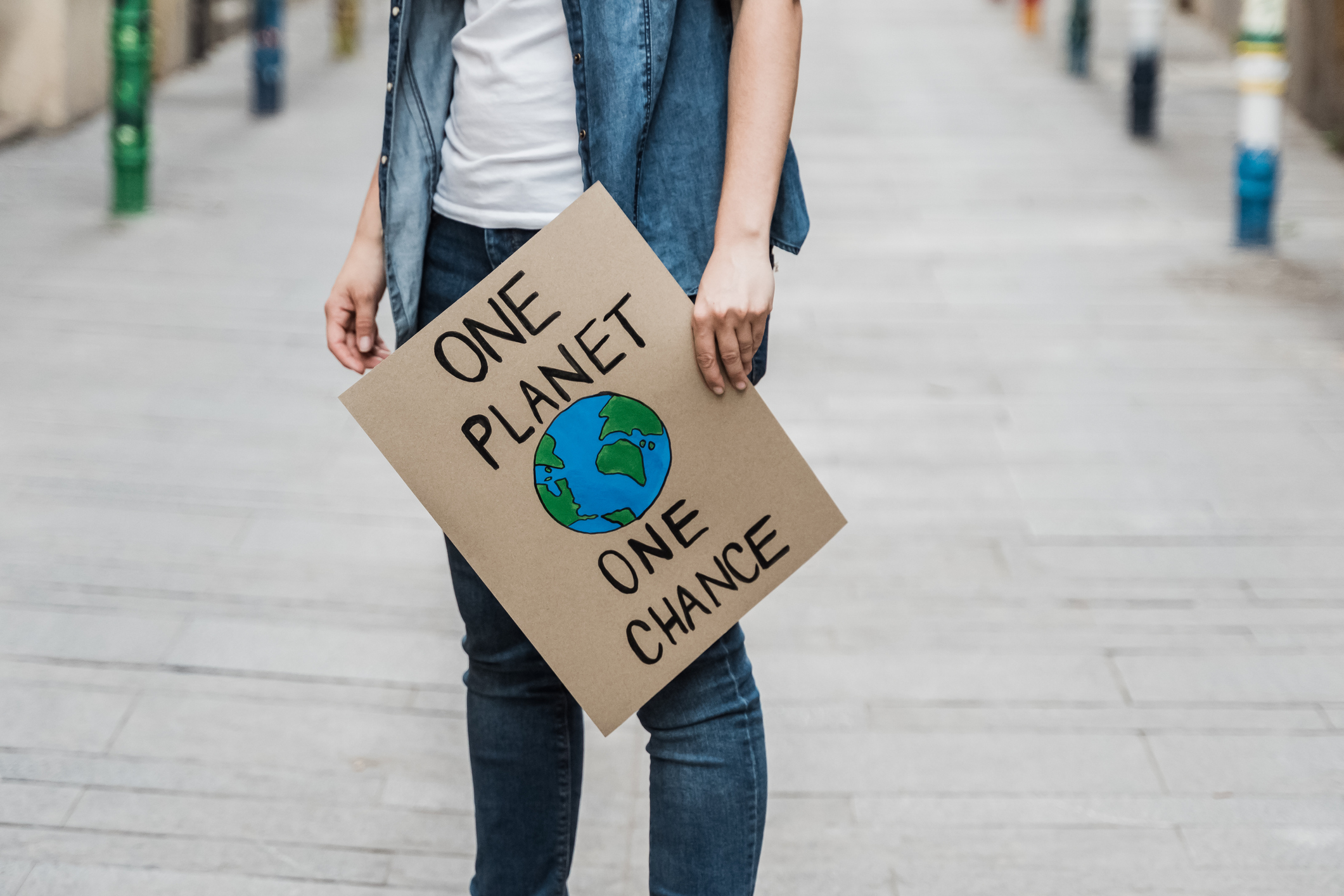 Protestor holding a sign reading One Planet One Chance.