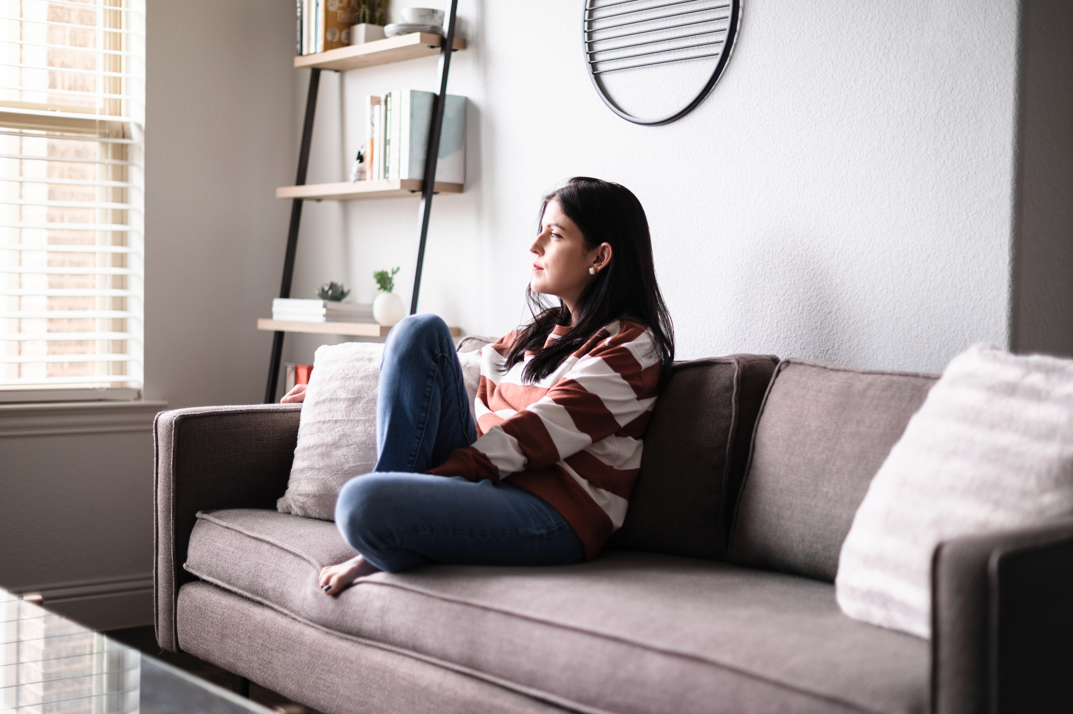person with a serious expression sitting on a couch