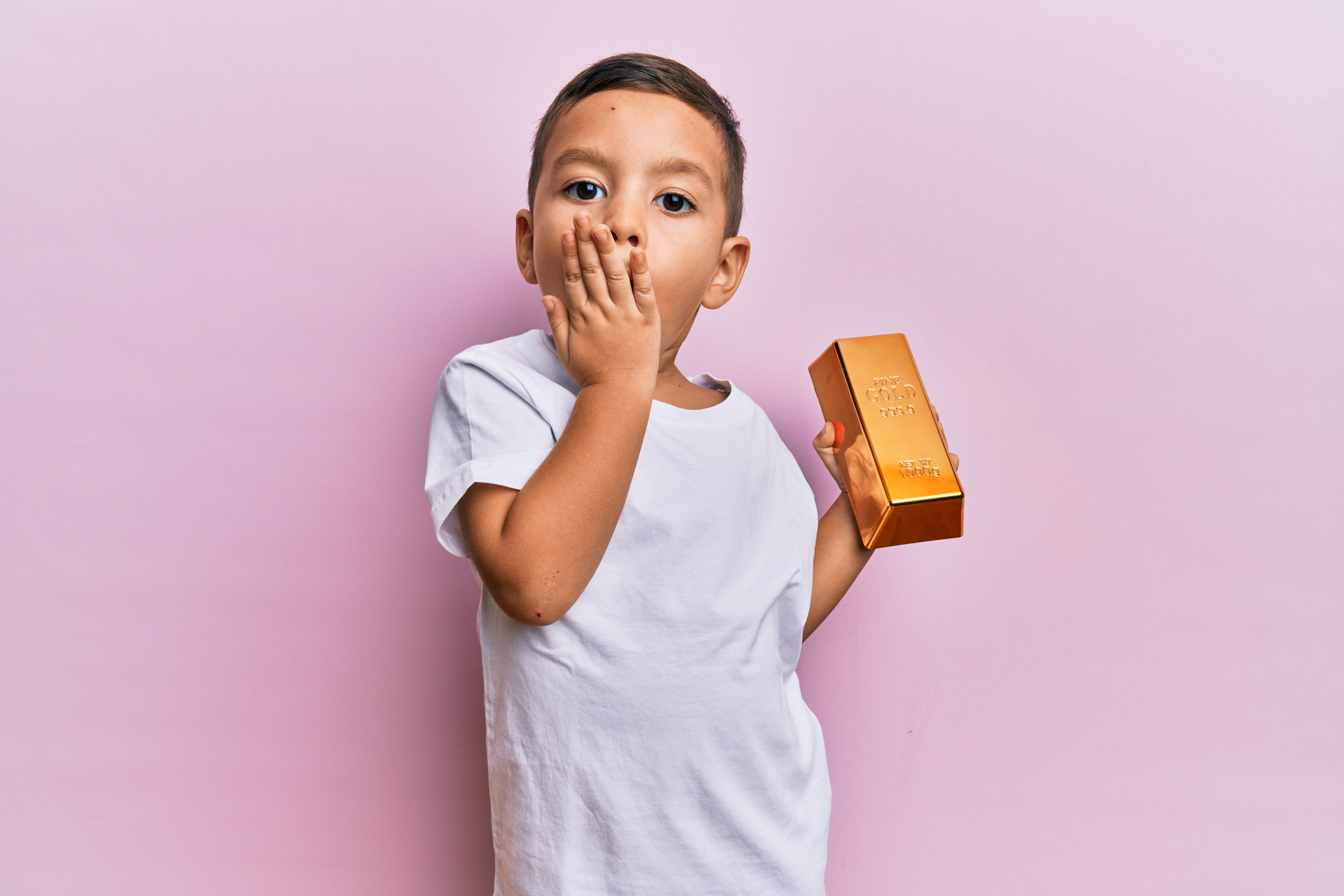 toddler holds a gold bar.