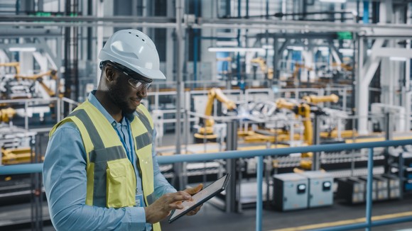 A factory engineer working in an industrial automotive facility.j