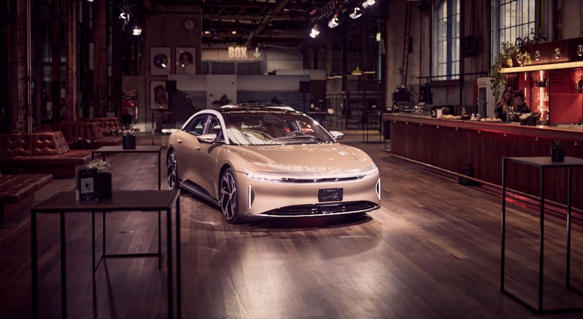 gold Lucid Air in showroom.