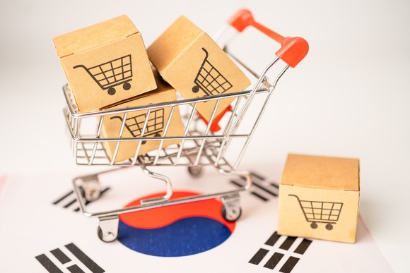 A tiny shopping cart placed on a South Korean flag.
