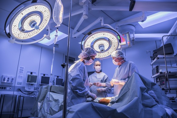 Surgeons perform a surgery in the operating room.