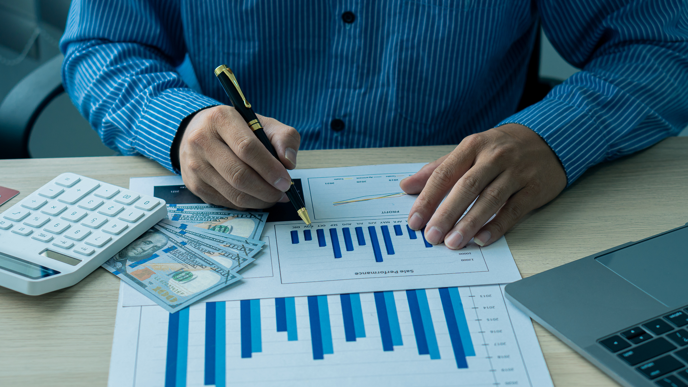 Person examining stock charts.