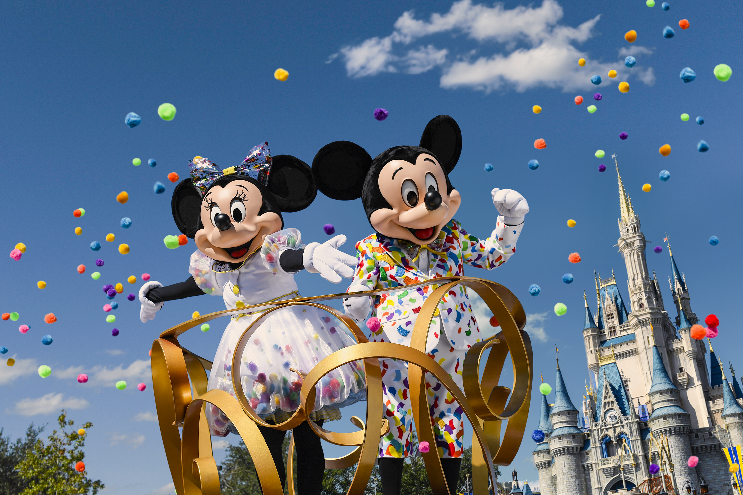 Mickey and Minnie Mouse on a parade float going down Main Street U.S.A.