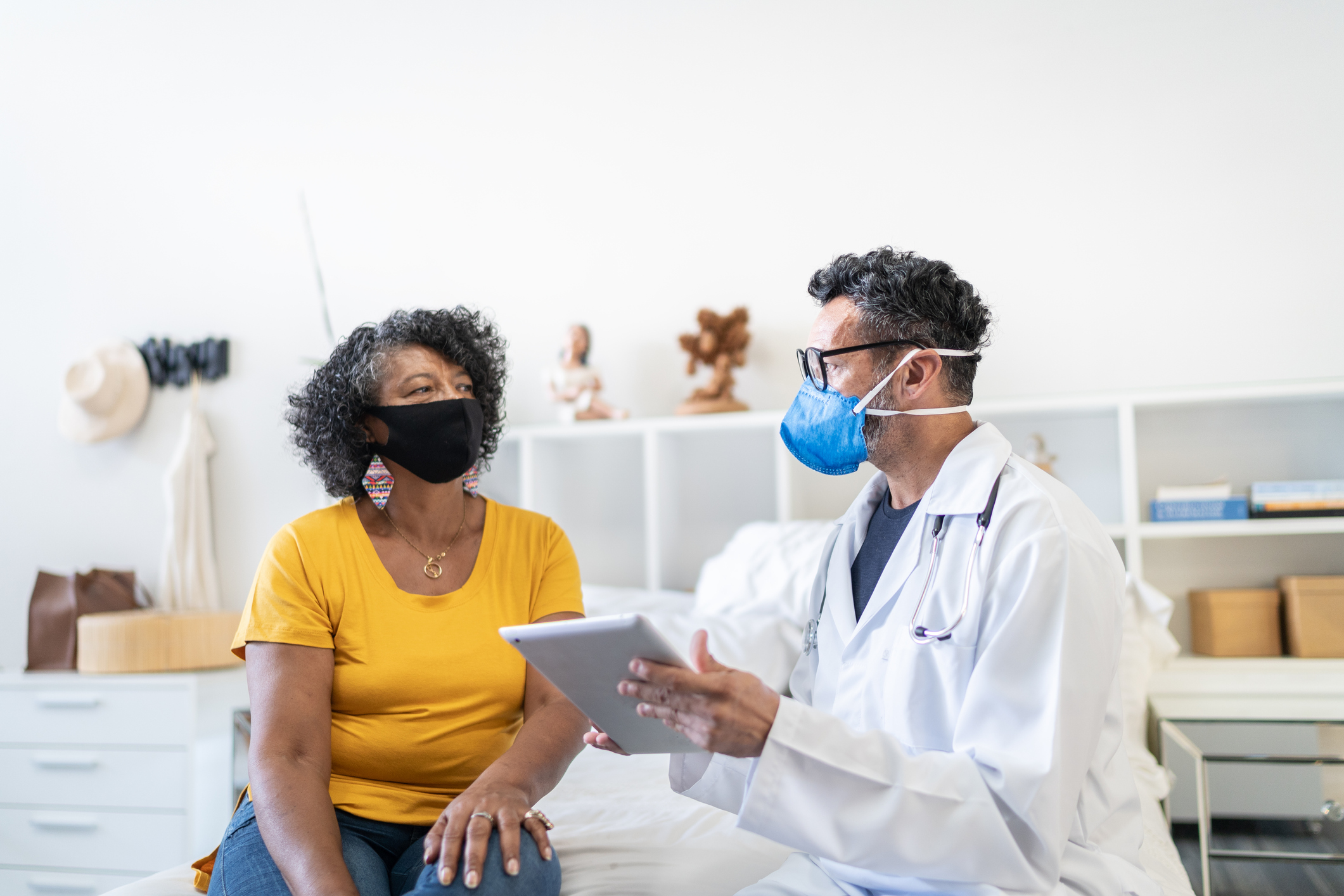 Doctor and patient speaking to each other at an appointment.