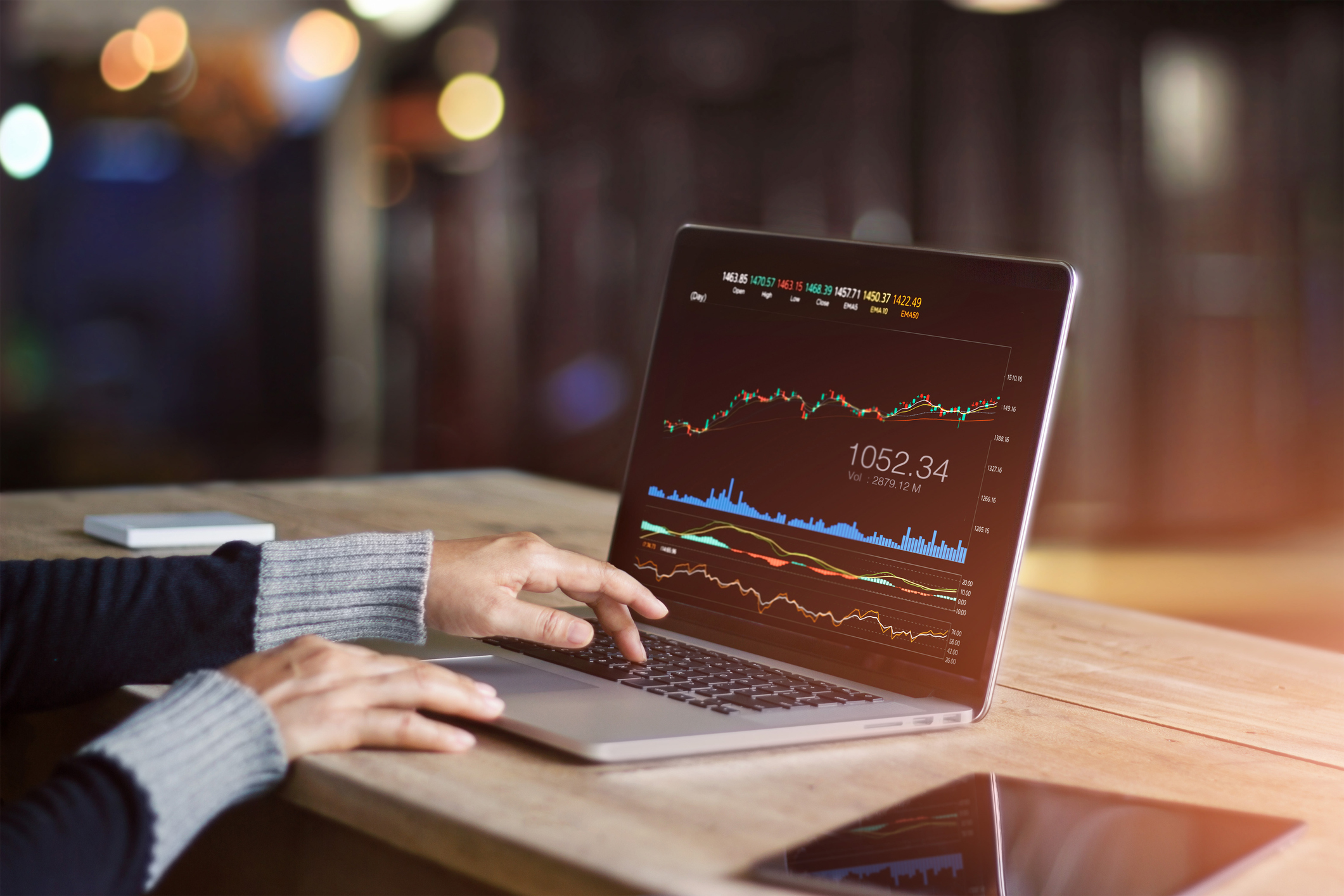 A person looking at a stock chart on laptop.
